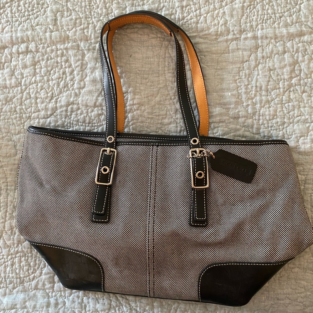 Coach black and white fabric patterned bag, with black leather straps and trim.